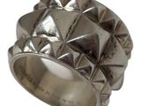 an image of a silver ring with pyramids on it