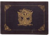 an old book with a gold eagle on it sitting on top of a table