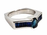an image of a silver ring with a blue stone in the middle