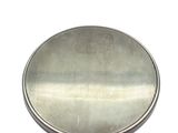a small round metal object on a white surface