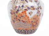a vase with a floral design on it on a white surface