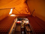a bed in a tent with a mattress on top of it