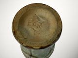 a brown vase with a face on it