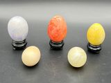 a group of four different colored eggs sitting on top of a table