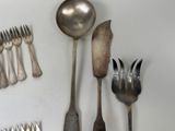 a lot of silver spoons and forks on the table
