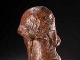 a carved head of a man with a beard on a black background