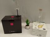 two wine glasses and a box on the bed