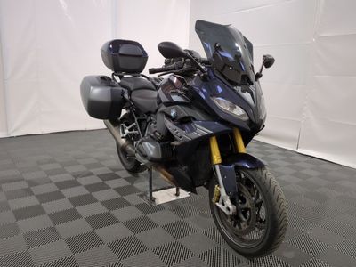 une moto qui est garée dans une pièce dont le sol est en damier