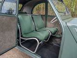 two seats in the back of a car with the door open