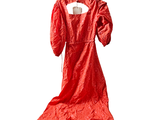 a red dress hanging on a hanger on a white wall