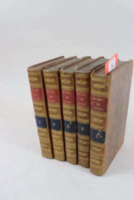 plusieurs livres sont empilés sur une surface blanche