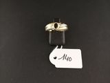 a close up of two rings on a black surface with a price tag