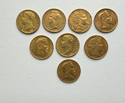 a bunch of gold coins sitting on top of a white surface