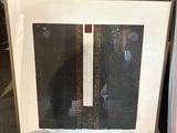 two framed pictures of a man in a suit and tie