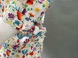 an image of a woman ' s dress with colorful flowers on it
