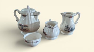 un service à thé en porcelaine composé de trois pièces posé sur la table