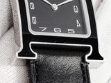 a close up of a wrist watch with a black face