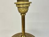 a gold colored candle holder on a white background
