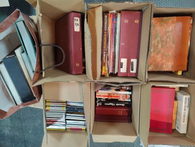 many books that are in a box on the floor