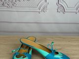 a close up of a pair of blue shoes on a wooden floor