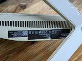 a close up of a white computer on a wooden table