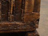 a wooden box with carvings on it sitting on a wooden floor