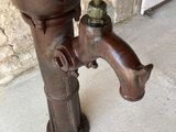 a water faucet that is attached to the side of a building