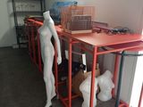 un mannequin debout à côté d'une table dans une pièce