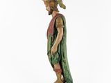 a wooden statue of a man with a beard and a green robe
