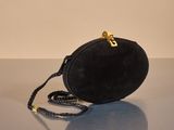 an image of a black purse on a table