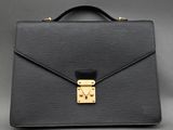 a black briefcase with a gold lock on it