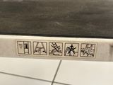 a close up of a metal table with a sticker on it
