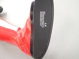 a red blow dryer sitting on a table next to a keyboard