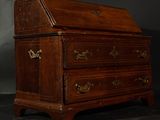 a small wooden desk with a drawer on top of it
