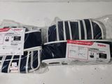 several pieces of luggage are wrapped in plastic bags on a table