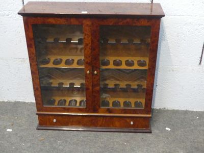a wooden cabinet with many bottles of wine in it