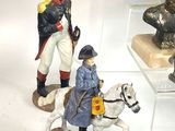 many figurines of soldiers on display in a glass case