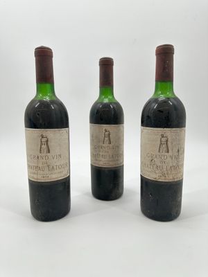 trois bouteilles de vin posées les unes à côté des autres sur une surface blanche
