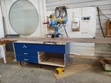 a picture of a workbench in a garage with a blue drawer