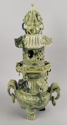 un vase vert surmonté d'un oiseau