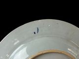 a white plate with a gold rim sitting on a table