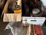 many boxes of items that are sitting on a bed