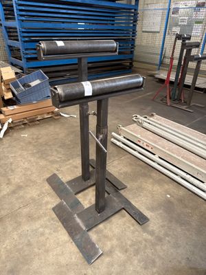 an image of a metal pipe on a stand in a warehouse
