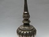 an antique silver plated candle holder on a white background