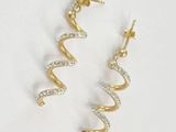 a pair of gold and diamond earrings on a white background