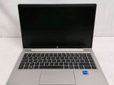an open laptop computer sitting on top of a white table