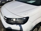 the front end of a white van parked in a parking lot