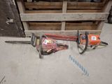 two chainsaws sitting next to each other on the floor