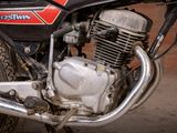 a close up of a motorcycle parked on the side of the street