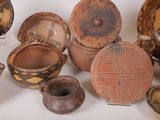 many different types of pottery on display on a table